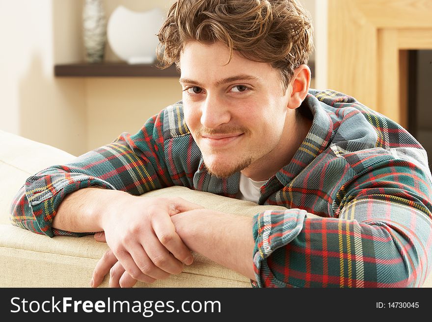 Man Relaxing On Sofa At Home