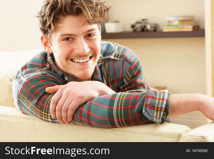 Man Relaxing On Sofa At Home