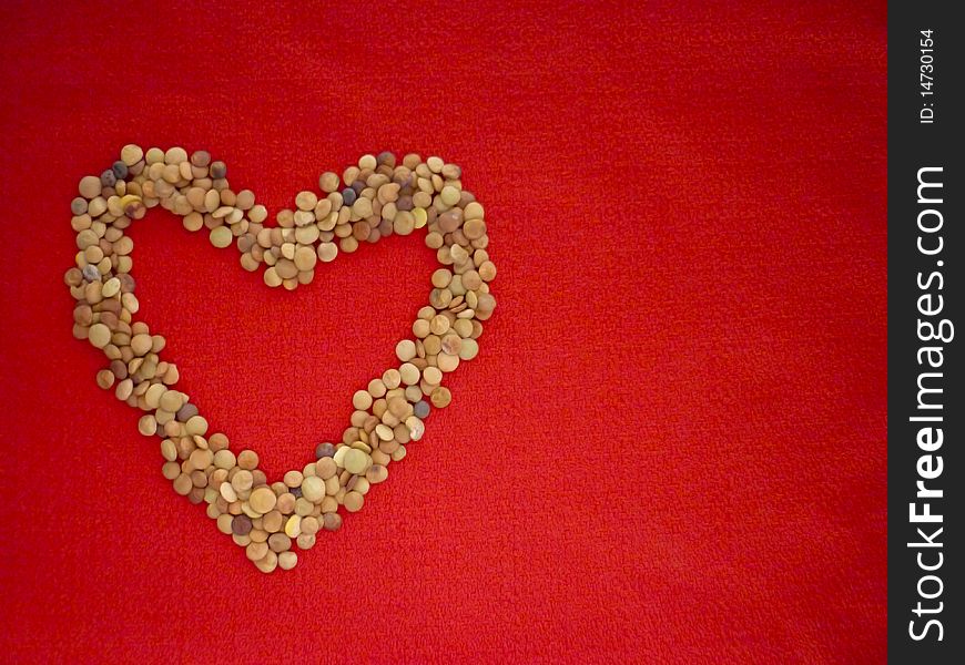 A heart of lentils on a red background. A heart of lentils on a red background