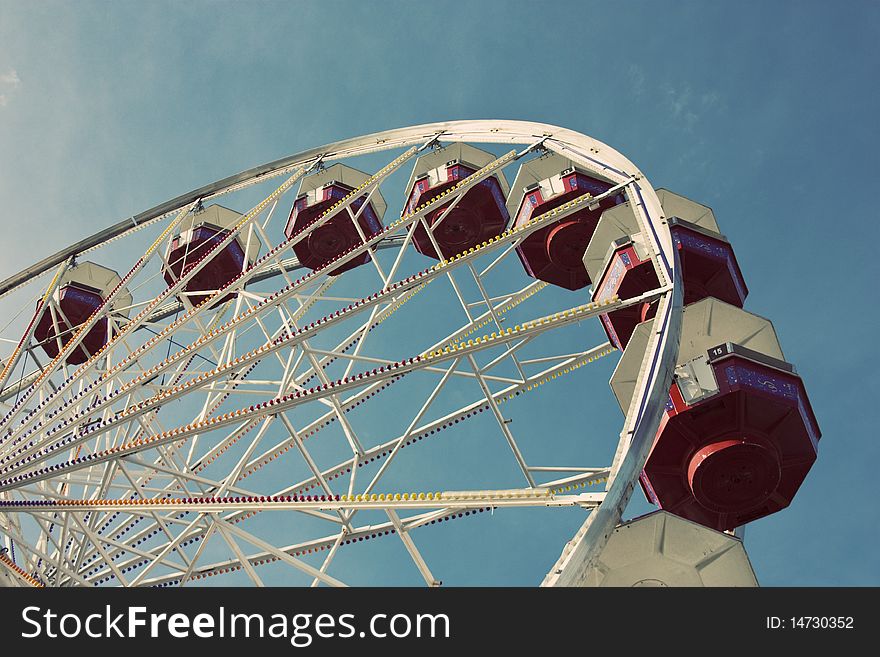 Looking up a ferris wheel with a blue sky background. Looking up a ferris wheel with a blue sky background
