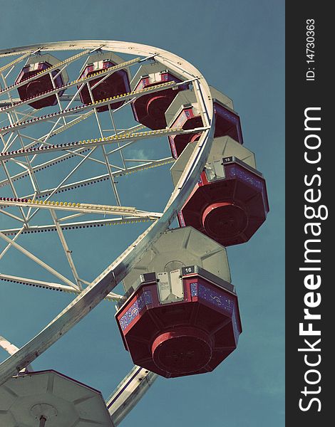 Looking up a ferris wheel with a blue sky background. Looking up a ferris wheel with a blue sky background