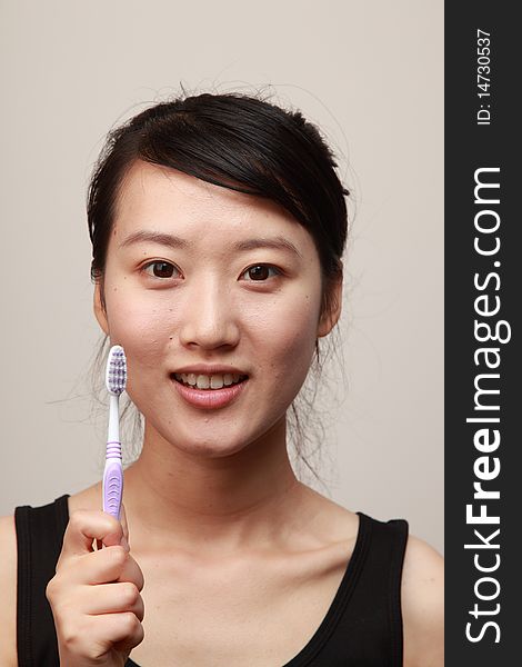 Attractive younug woman with a tooth-brush. Attractive younug woman with a tooth-brush