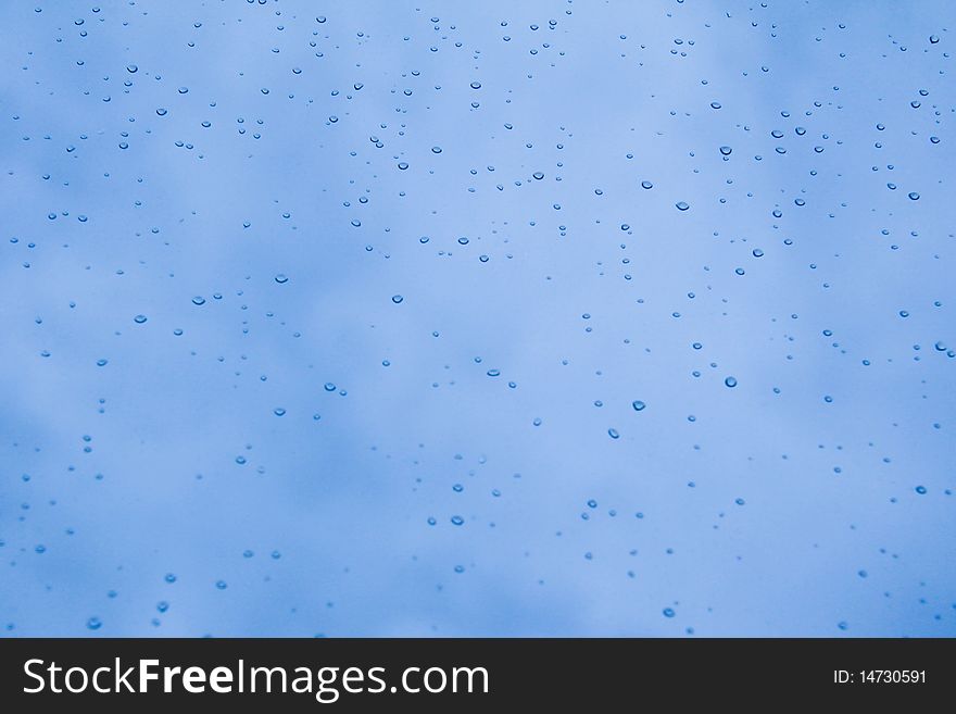 Raindrops on a background of blue sky