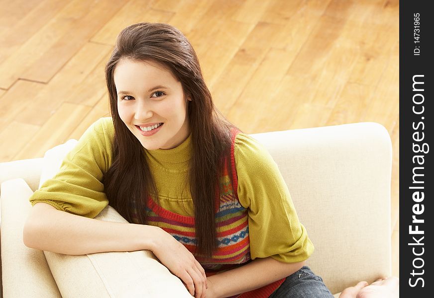 Woman Relaxing On Sofa At Home