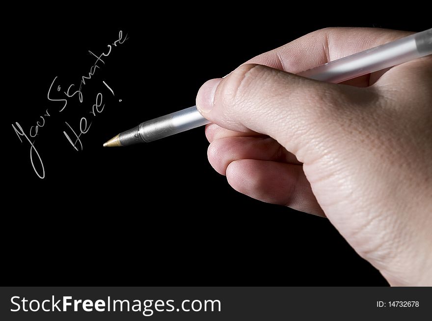 Isolated hand and pen with copy space on black background