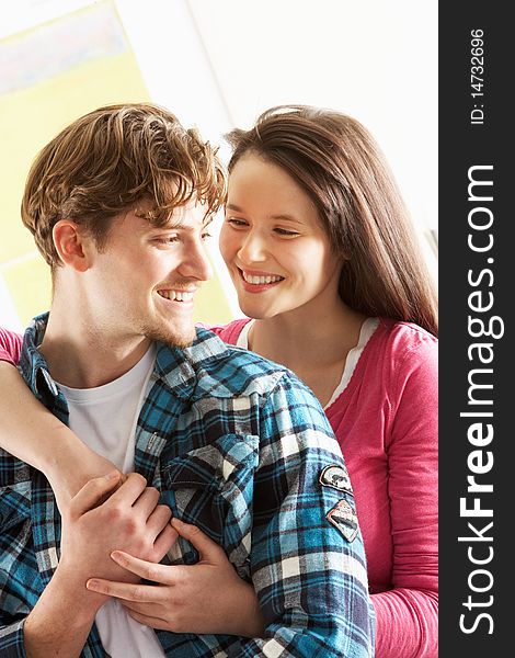 Romantic Young Couple Embracing In Living Room