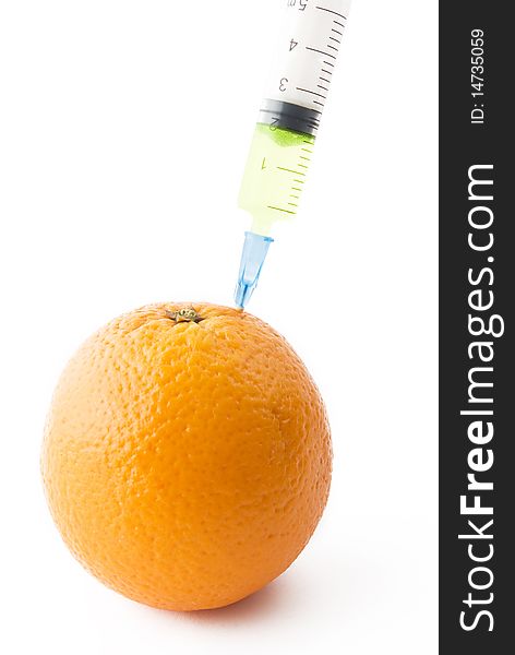 Juicy Orange with medical syringe over white