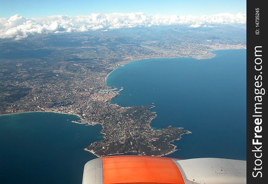 Looking from an aeroplane down at the blue sea and coast of the Cote d'Azur. Looking from an aeroplane down at the blue sea and coast of the Cote d'Azur