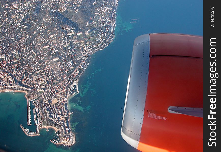 Looking from an aeroplane down at the blue sea and coast of the Cote d'Azur. Looking from an aeroplane down at the blue sea and coast of the Cote d'Azur