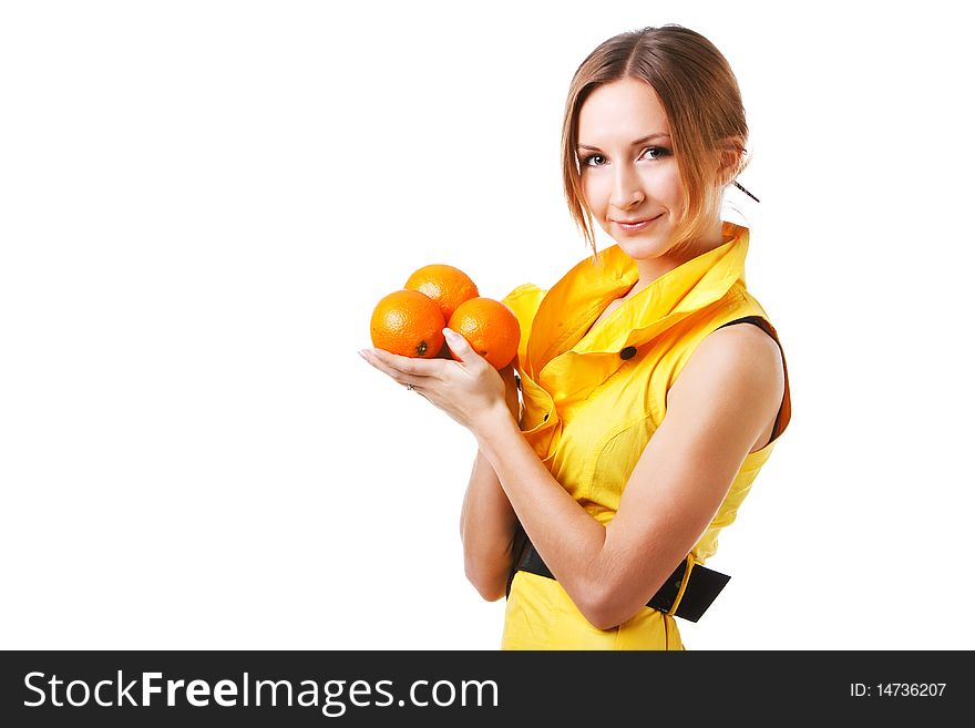 Picture of a young pretty girl in yellow dress which holds oranges. Isolated on white. Picture of a young pretty girl in yellow dress which holds oranges. Isolated on white.