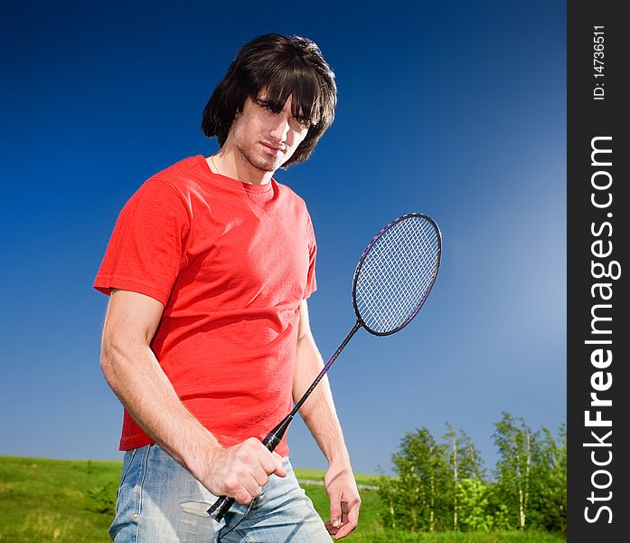 Boy in jeans with racket. Boy in jeans with racket