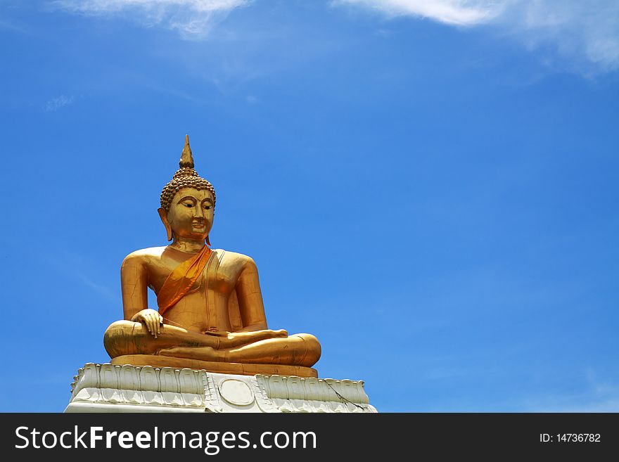 Old golden buddha with cracked texture in clear sky.Phetchaburi Thailand.