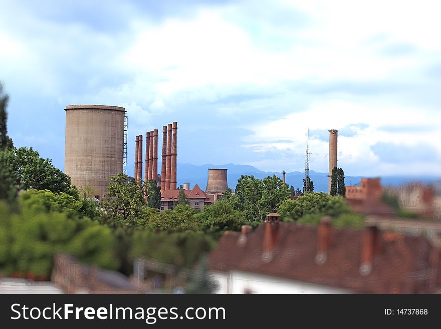 This is a picture with a view over an industrial city. This image was intentionally blurred for a better focused on the main subject!