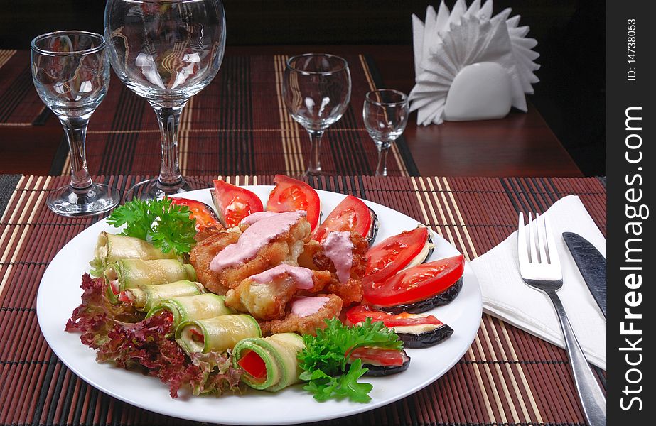 Meat and vegetables with sauce on white dish. Meat and vegetables with sauce on white dish