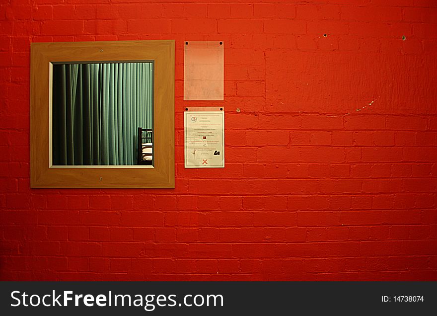 Wooden mirror on a red brick wall. Wooden mirror on a red brick wall