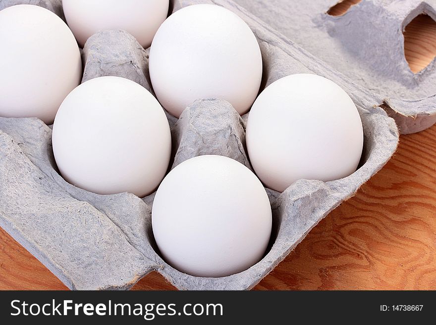 Eggs of white colour are combined in a special tray for transportation and sale.