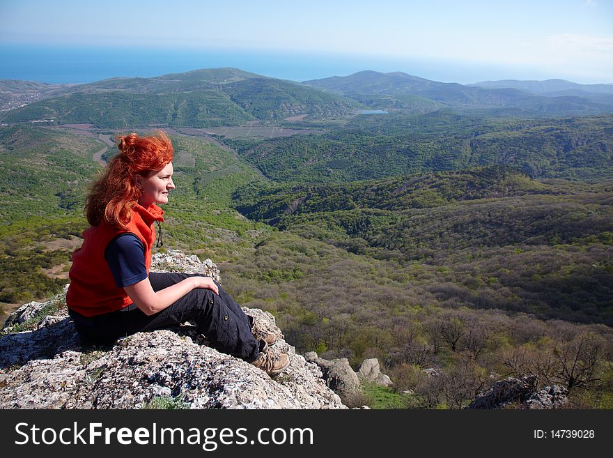Woman sitting on a high cliff. Woman sitting on a high cliff
