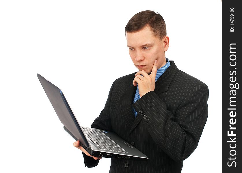 Businessman thinking over his laptop computer