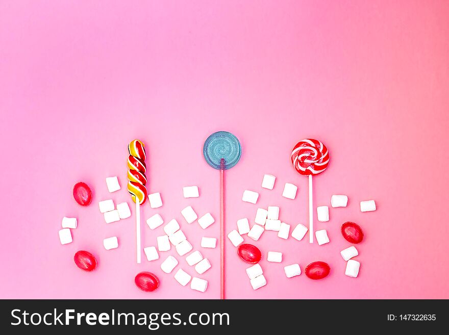 Flat Lay Composition With Yummy Lollipops And Marshmallows And Space For Text On Pink Background