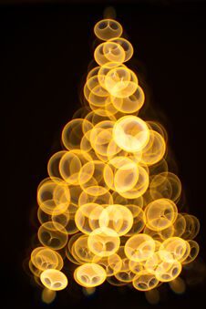 Golden Christmas Tree Bokeh In A Black Background Royalty Free Stock Images
