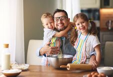 Free Father With Children   Baking Cookies Stock Images - 147369254