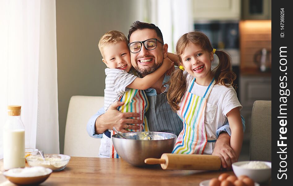 Father with children preparing food, baking cookies. Father with children preparing food, baking cookies