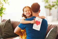 Free Father`s Day. Happy Family Daughter Hugging Dad And Laughs Royalty Free Stock Image - 147370106