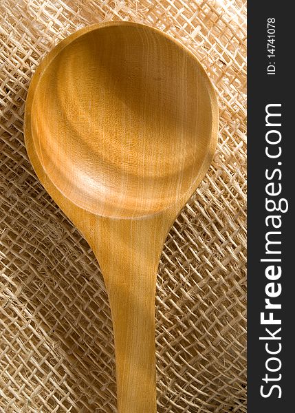 Still life: wooden spoon over straw