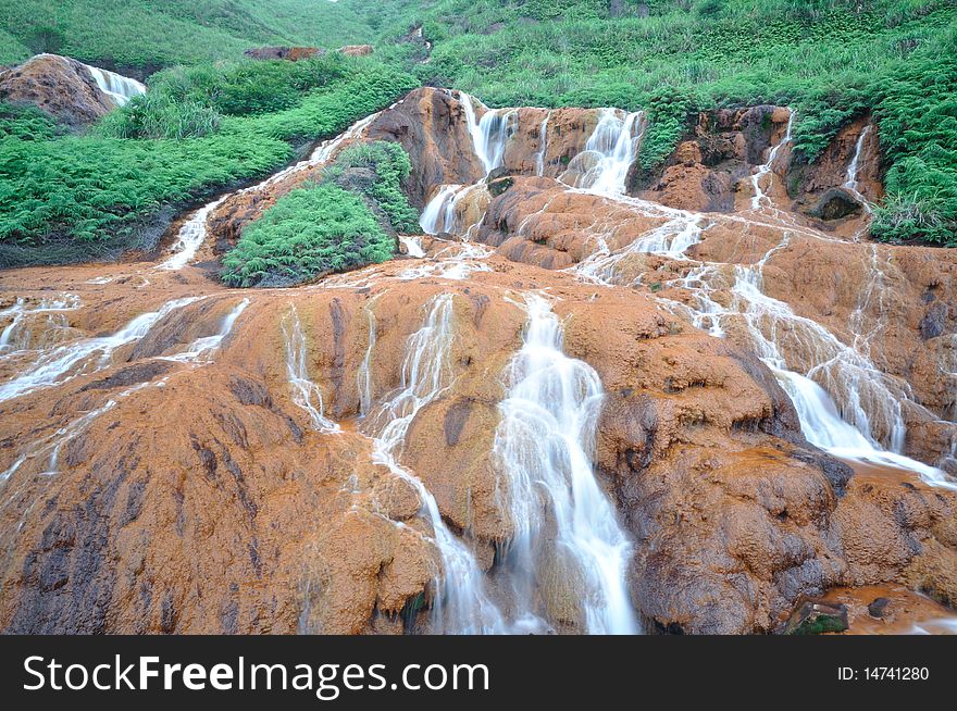 It is a waterfall on red soil, called gold fall