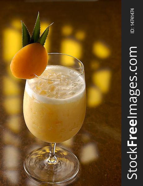 A Colada cocktail with a slice of an Apricot.
