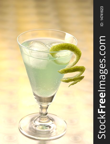 Green Fizz with a slice of lime and crushed ice