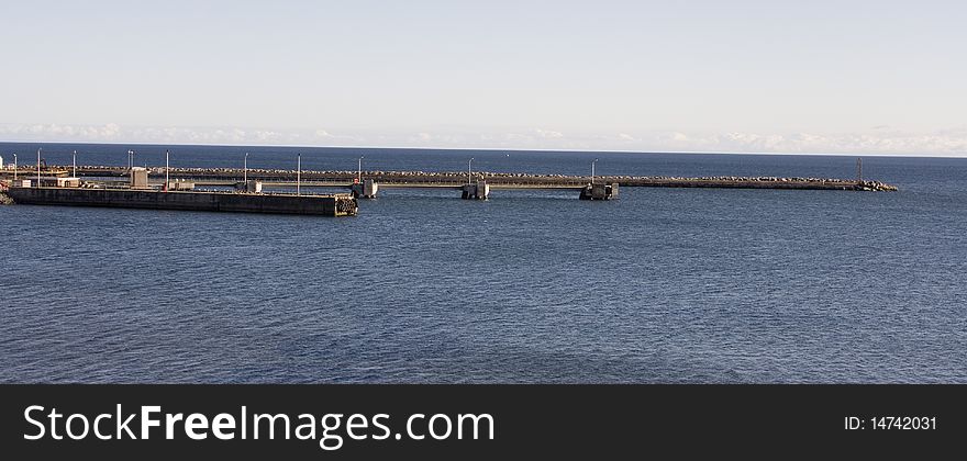 The docks of the harbor go out in the Atlantic