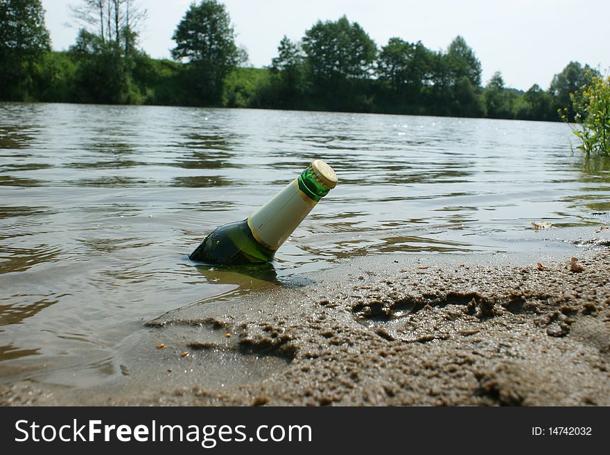 Cold bottle of a beer in the river. Cold bottle of a beer in the river