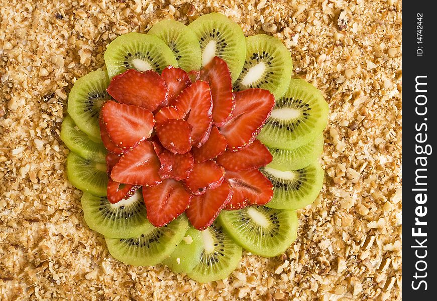 Home sponge cake with strawberries and kiwi on a stand on a white background