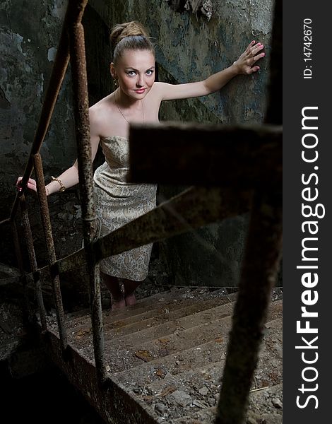 Beautiful woman standing on the grungy stairs