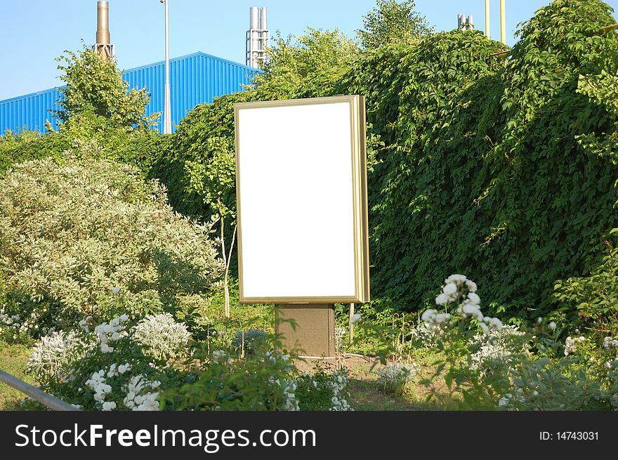 White publicity board in greens of bushes. White publicity board in greens of bushes