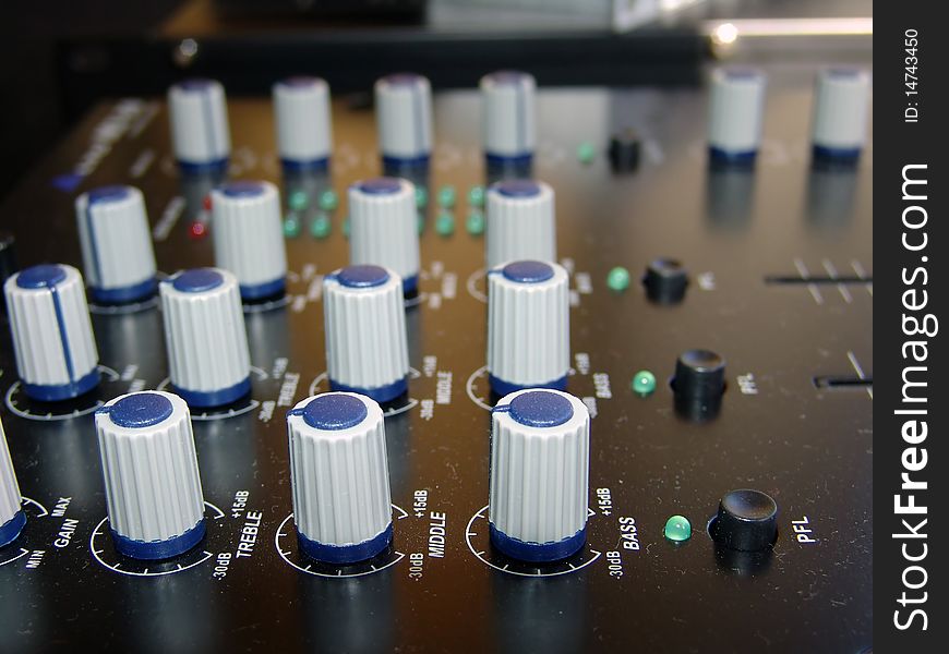 Closeup of an audio mixer console in a recording studio
