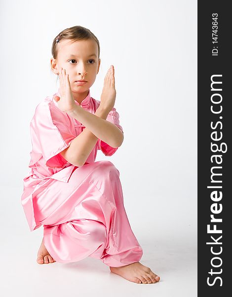 Girl in a pink kimono engaged wushu