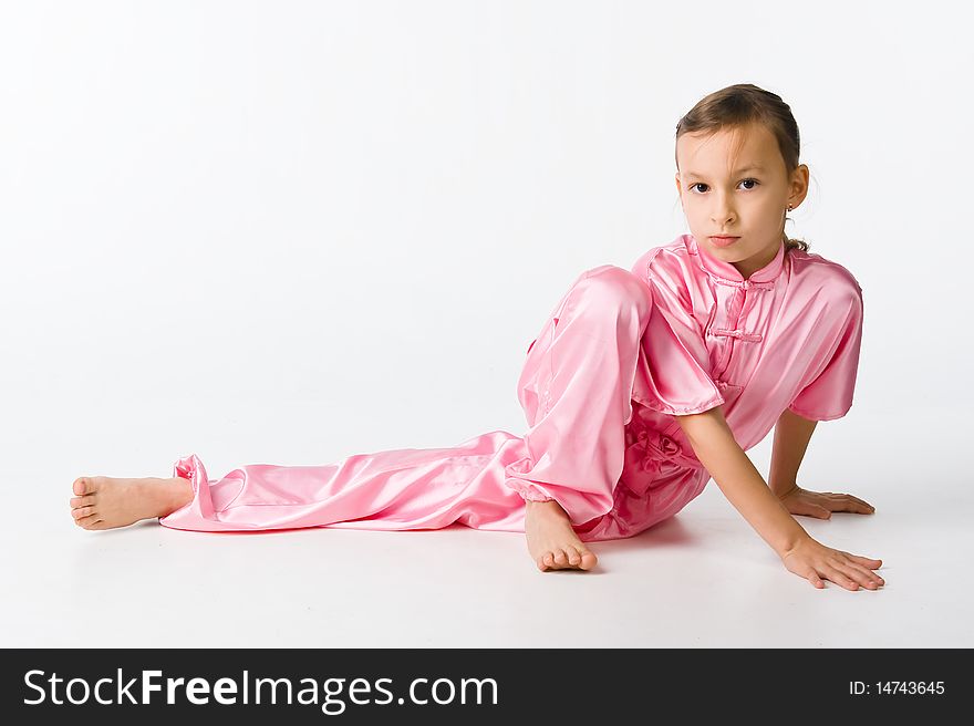 Girl in a pink kimono sitting on the floor
