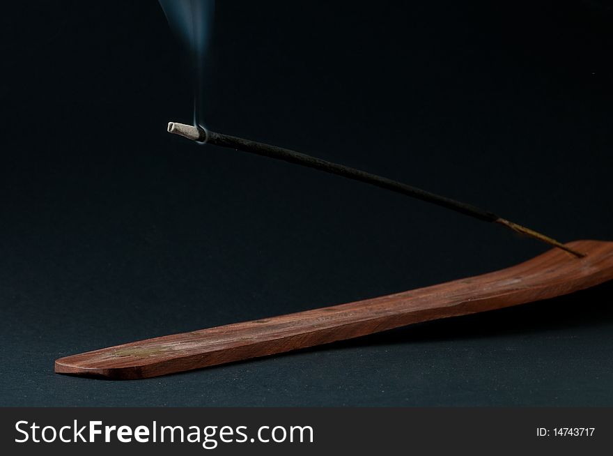 Burning incense stick in holder. Burning incense stick in holder