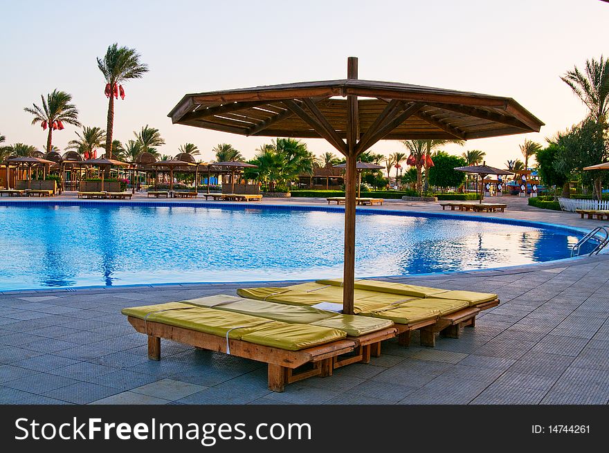 The sunbed next to swimming pool. The sunbed next to swimming pool.