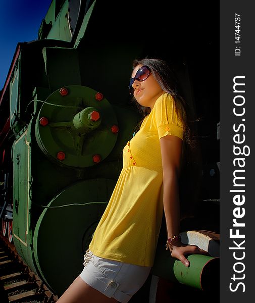 Girl In Glasses With Train On Background.