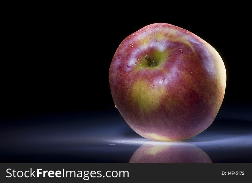 The apple on a dark background