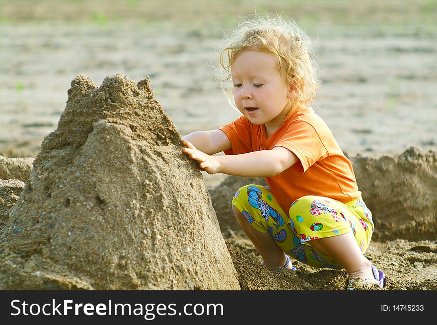 Girl Playing With Wet Sand