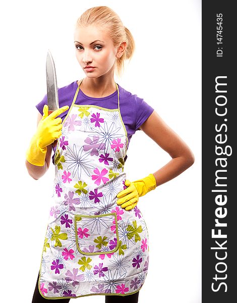 Young beautiful housewife in rubber yellow gloves with knife. Young beautiful housewife in rubber yellow gloves with knife