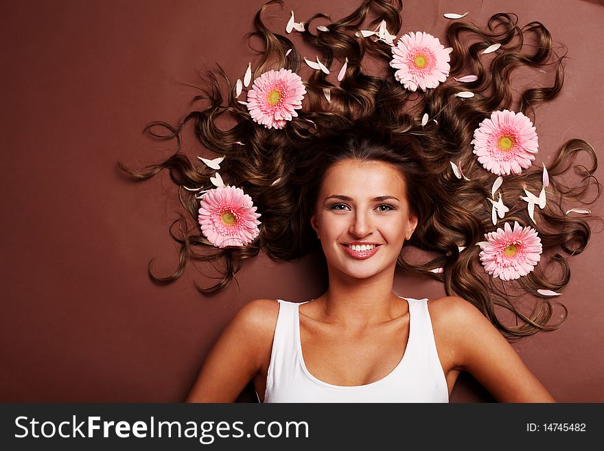 Young beautiful woman with pink fresh flower. Young beautiful woman with pink fresh flower