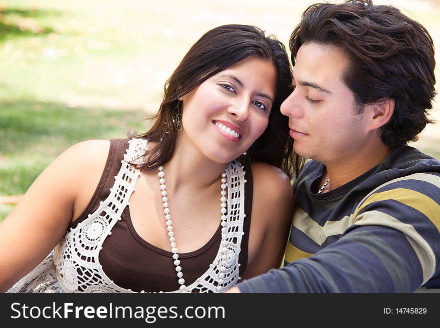 Attractive Hispanic Couple Portrait Enjoying Each Other Outdoors. Attractive Hispanic Couple Portrait Enjoying Each Other Outdoors.