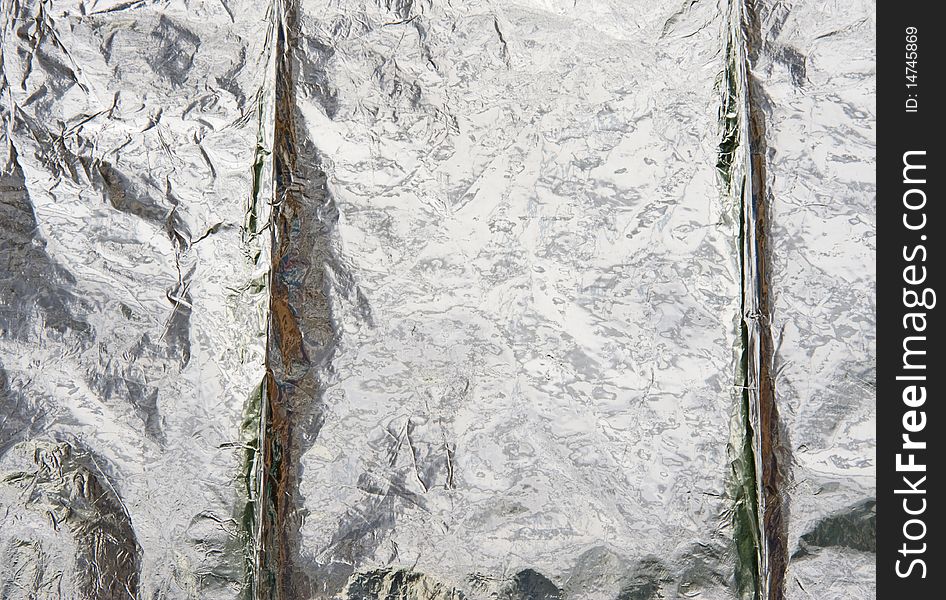 Aluminium foil reflecting background.