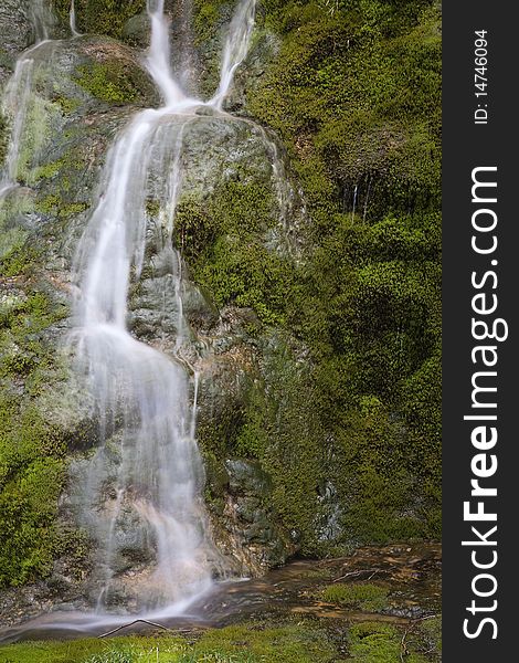 Waterfall in a birth of a river in the autumn with the trees without leaves. Waterfall in a birth of a river in the autumn with the trees without leaves