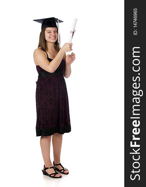 A silly young teen in her graduation cap delighted with her diploma. Isolated on white. A silly young teen in her graduation cap delighted with her diploma. Isolated on white.